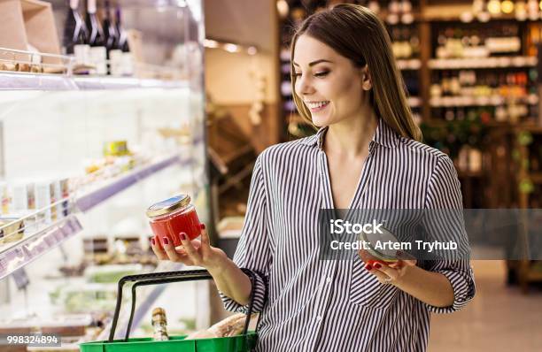 Woman Choosing Red Caviar At Fish Supermarket Stock Photo - Download Image Now - Supermarket, Market - Retail Space, Shopping