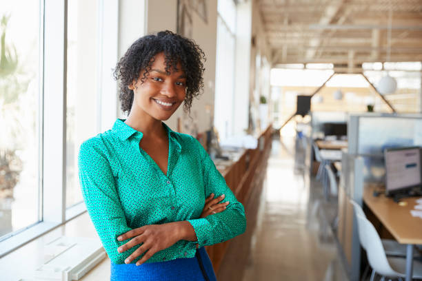 istock Young black female architect smiling to camera in an office 998329124