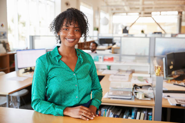 istock Black female architect in open plan office smiling to camera 998329554