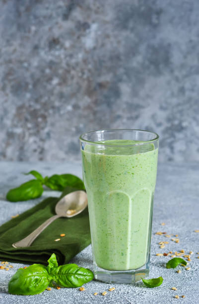 istock Vegetable smoothies from yogurt, spinach, basil and avocado with chia seeds on a concrete background. Detox drink. Proper nutrition. 998333938