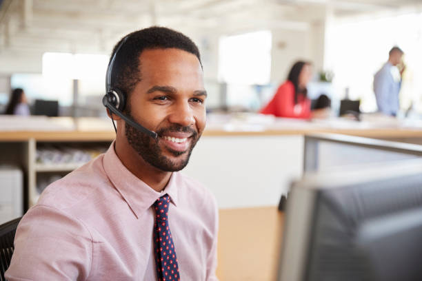 istock Black male call centre worker looking at screen, close-up 998336850