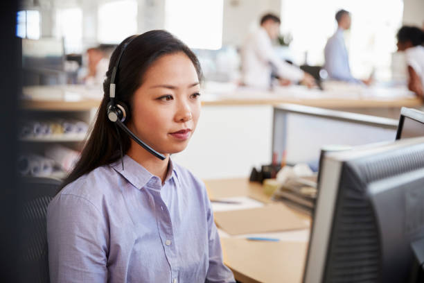 istock Young Asian woman working in a call centre 998337290