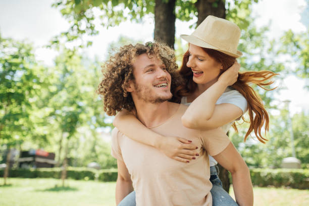 istock Young happy man carrying girlfriend on his back 998337612