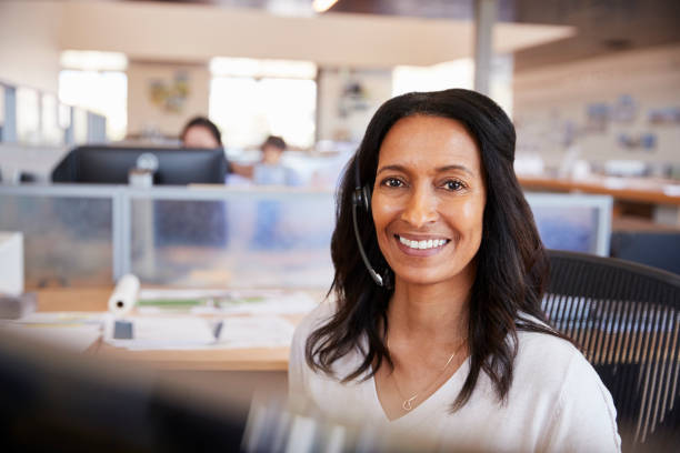 istock Young mixed race woman in a call centre looking to camera 998337732