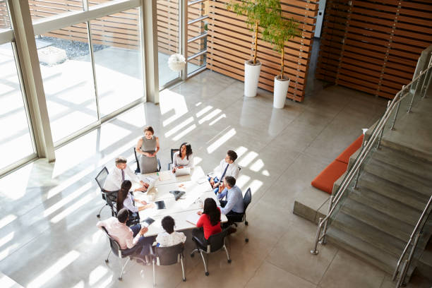 istock Female manager addressing a team meeting, elevated view 998338414