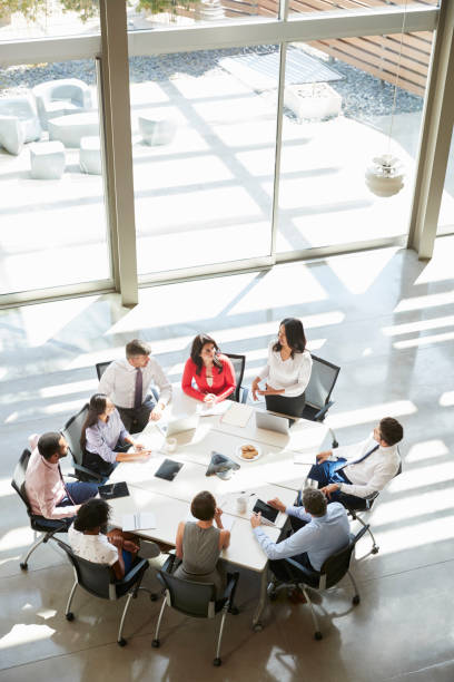 istock Businesswoman addressing meeting, elevated view, vertical 998338444