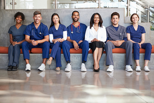 Healthcare workers sitting in a modern hospital, low angle