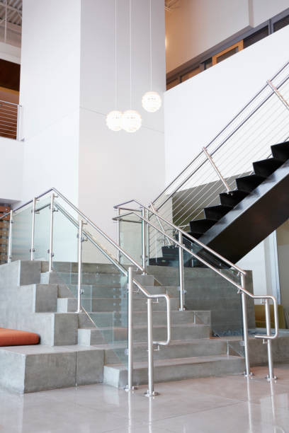 istock Atrium lobby and stairs in modern office building, vertical 998342268