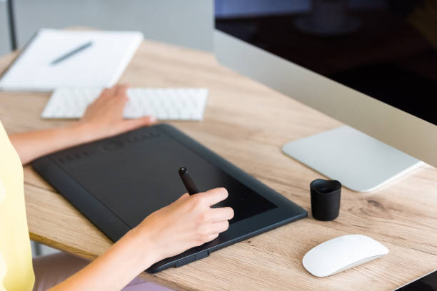 istock cropped image of female freelancer drawing on graphic tablet at table with computer 998343116