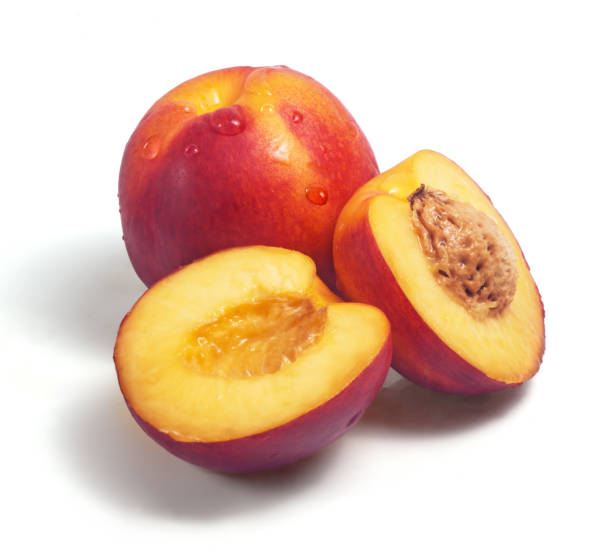 istock Group of fresh nectarines covered with water drops isolated on white background 998369004