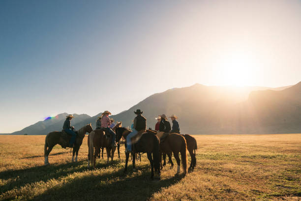 istock Horse riders on horses at sunrise 998378720