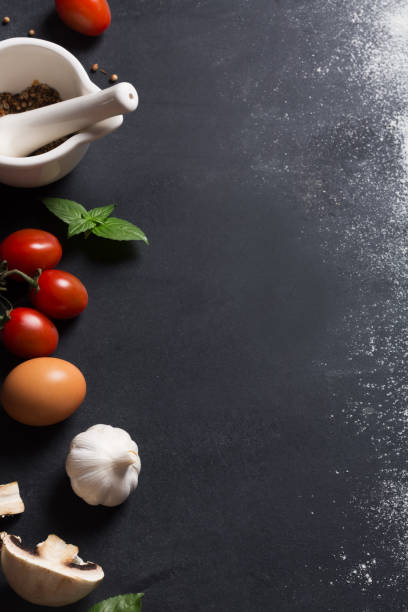 istock Baking background with copy space and vegetables on black surface for your text. Top view, vertical orientation 998385180