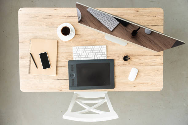 istock top view of workplace with computer, smartphone, graphic tablet and coffee cup on table in office 998391150