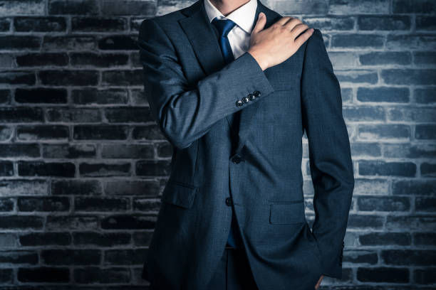 istock businessman standing front of a brick wall 998396018
