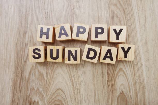 istock happy sunday on wooden background 998396530