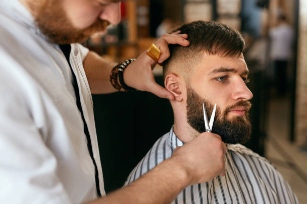 istock Beard Cut In Barber Shop. Barber Cutting Beard 998404028