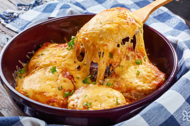 istock Pork Chops Topped with Onions, Mayo and stringy melted Cheese 998407930