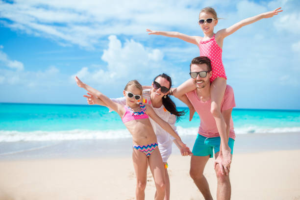 istock Happy beautiful family on the beach 998411544