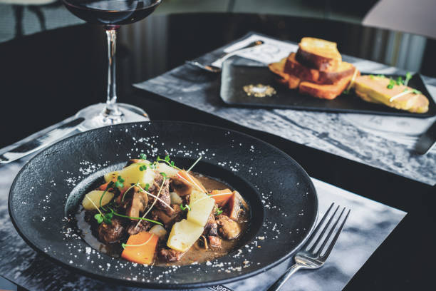 istock Romantic dinner in the resraurant. Two appetizing dishes and gla 998421888