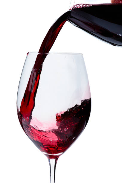 istock Alcoholic drink. Pouring expensive red wine from bottle into the 998422786