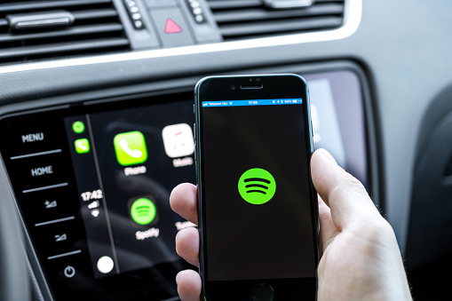 Miskolc, Hungary - May 20, 2018: Spotify starting up on an iPhone 8 connected to a new Skoda car.