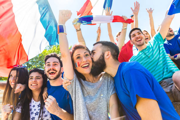 istock France supporters celebrating at stadium with flags 998425904