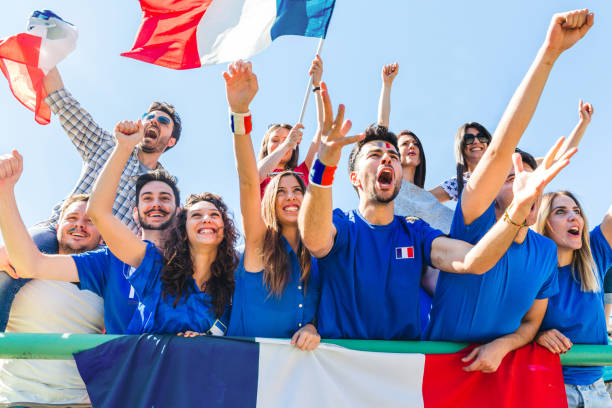 istock France supporters celebrating at stadium with flags 998425938