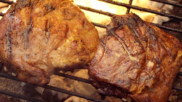 istock Barbecued Pork Baby Back Ribs on a Sizzling Grill 998426090