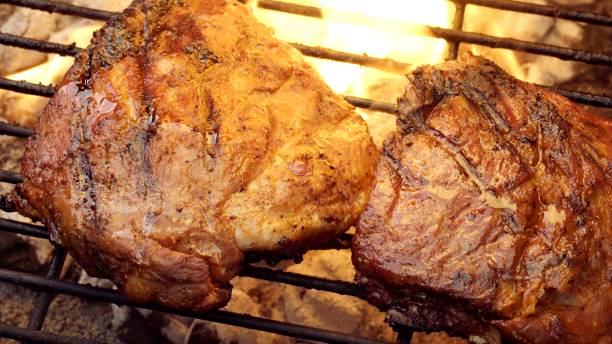 istock Barbecued Pork Baby Back Ribs on a Sizzling Grill 998426108