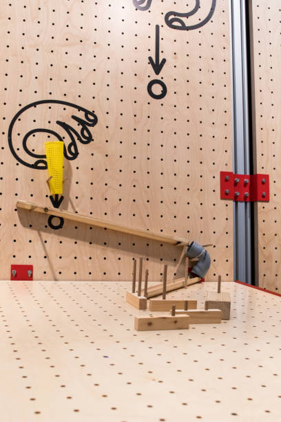 istock Wooden constructions to create a pipes path to a ball. 998432932