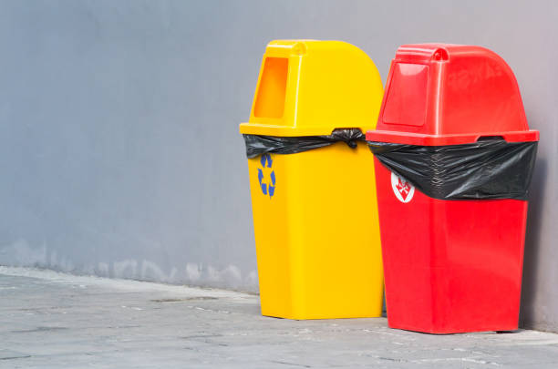 istock yellow and red plastic recycling bin on foot path. concept : separate waste junk 998444252