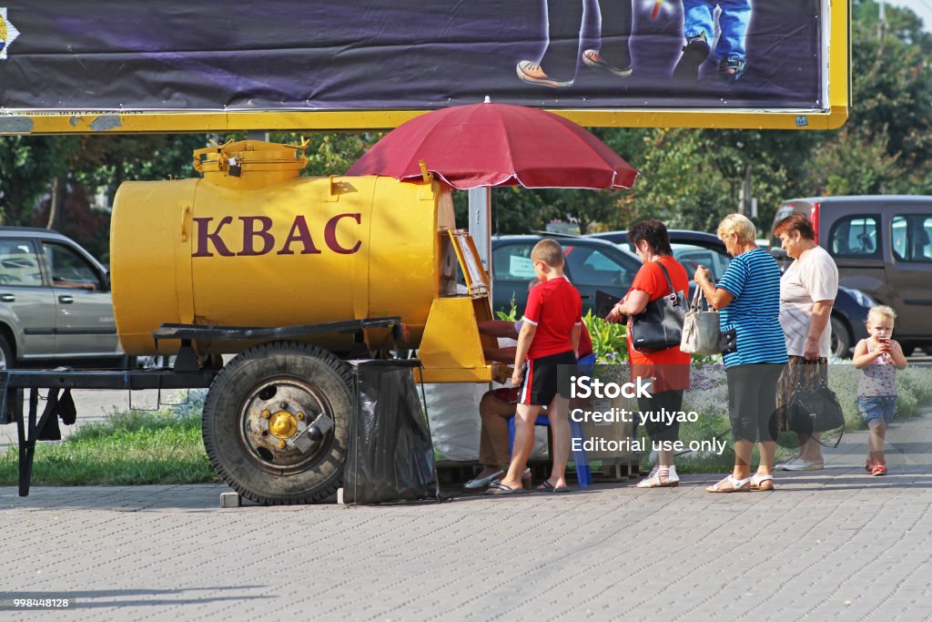 В Слуцке люди покупают квас из желтой бочки на улице - Стоковые фото Белоруссия роялти-фри