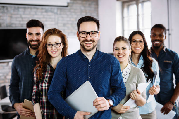 Portrait of successful business team posing in office Portrait of successful young business team posing in office business relationship photos stock pictures, royalty-free photos & images