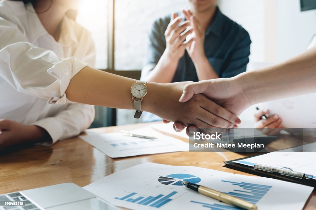 Close up of Business people shaking hands, finishing up meeting, business etiquette, congratulation, merger and acquisition concept Making Stock Photo