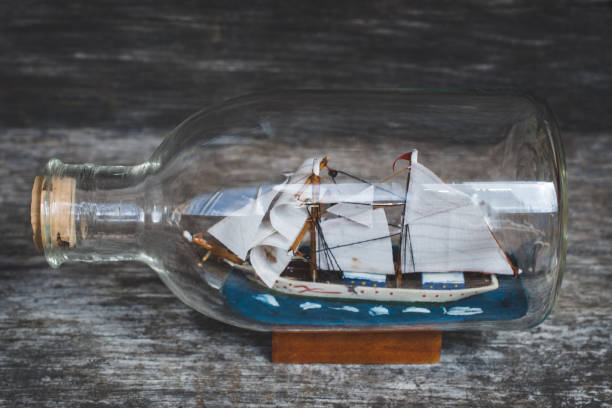 istock boat in the bottle on wooden table 998457854