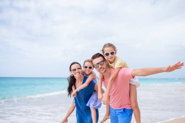 istock Happy beautiful family on the beach 998460304