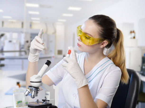 istock Young beautiful girl lab assistant in a laboratory 998466200
