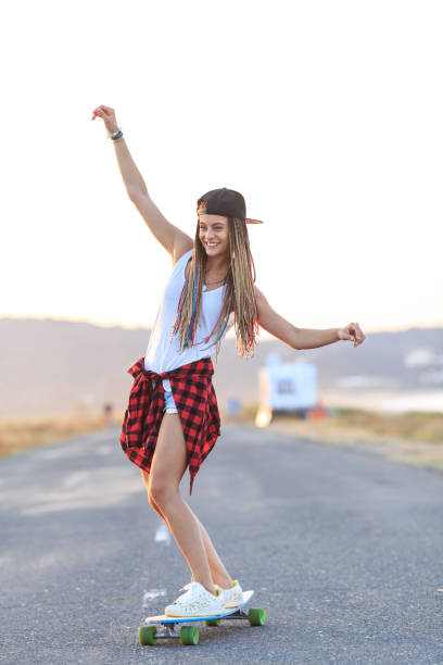 istock Smiling skater moving down on country road 998468918