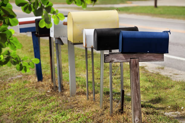 istock Close up colorful mailboxes in a row by road 998472988