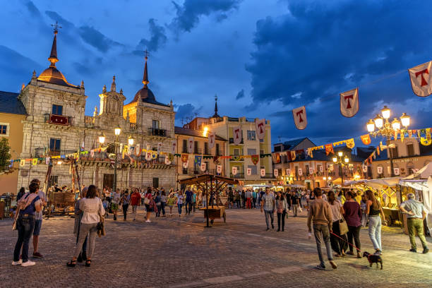 View of the Medieval Fair at Ponferrada City Hall plaza during Templar night festivities. Night view of the Medieval Fair at City Hall plaza during popular Templar night festivities in Ponferrada, northern Spain. knights templar stock pictures, royalty-free photos & images