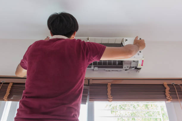 istock Man clean air conditioner at home 998477140