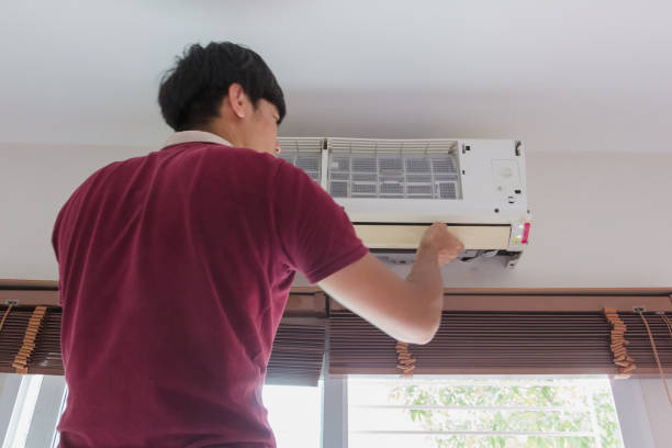 istock Man clean air conditioner at home 998477480