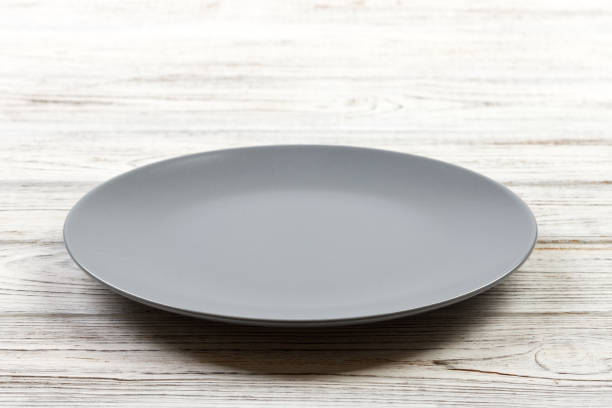istock Perspective view. Empty Gray round plate on wooden background 998478050