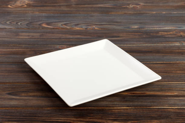 istock Perspective view A square plate on the white wooden table 998478126