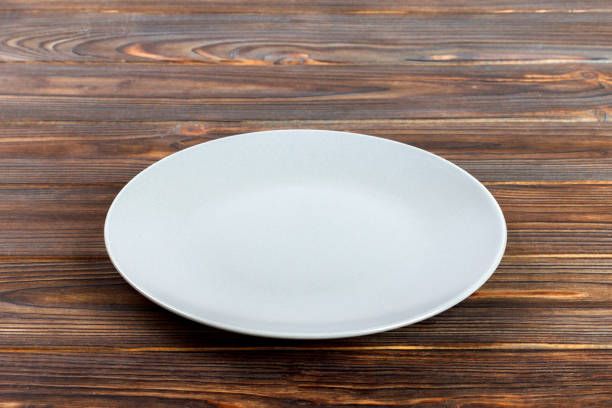 istock Blank gray empty round plate on a wood background 998478134