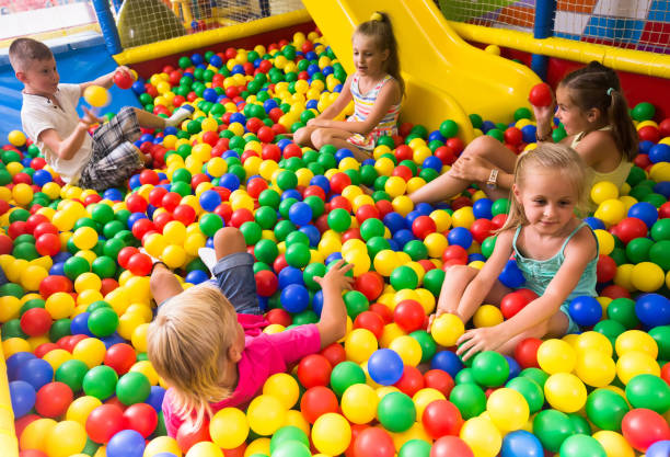 istock children playing together in pool with plastic multicolored balls 998481986