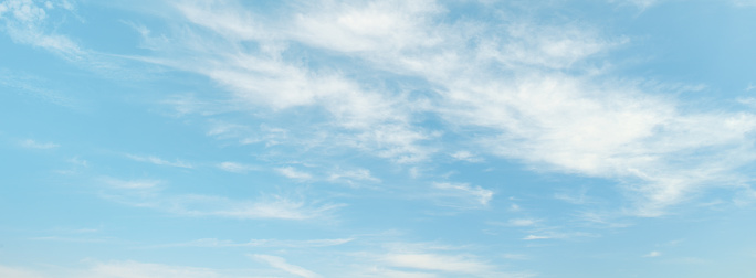 Light clouds on light blue sky background.