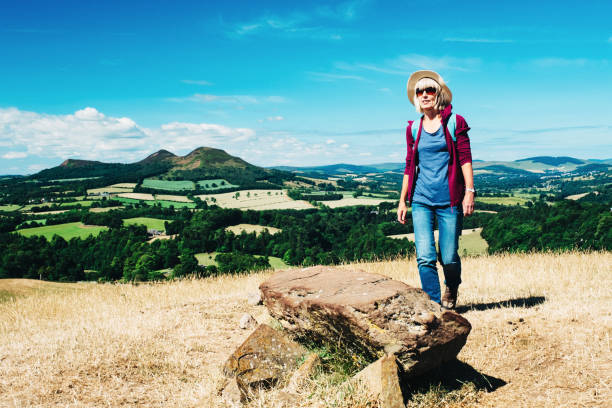 Active senior woman walking on a grass meadow
