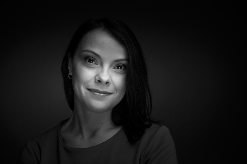 Portrait of a young black haired woman. Fine film grain texture.