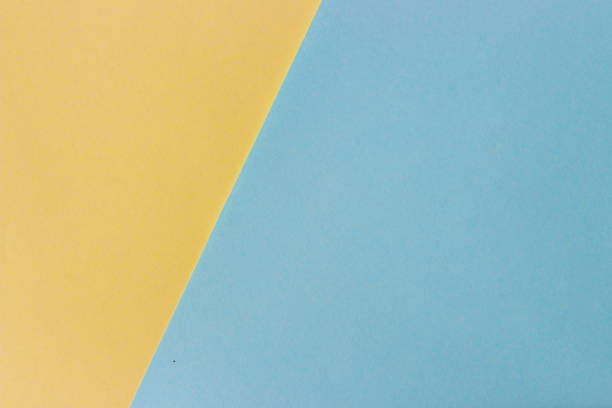 istock abstract colored paper, Pastel yellow and blue background 998502214